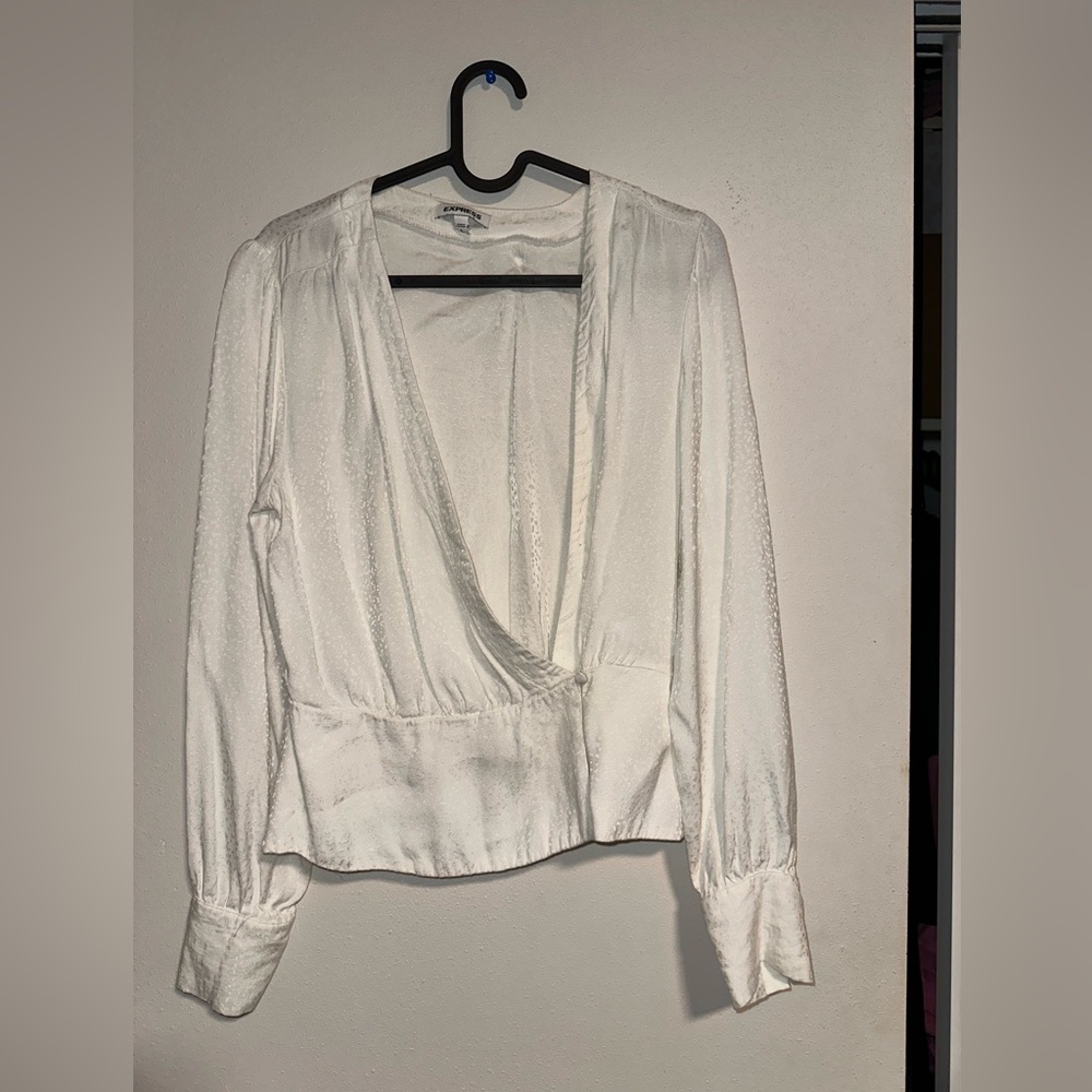 White express wrap blouse. It is off white with print.